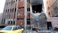 Syrians check the site of a double suicide bomb attack which hit the al-Midan police station in Syria's capital Damascus on October 2, 2017.   AFP / LOUAI BESHARA
