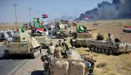 Shi'ite Popular Mobilization Forces (PMF) and Iraqi army members gather on the outskirts of Hawija, Iraq October 4, 2017. REUTERS/Stringer