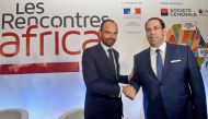 Tunisian Prime Minister Youssef Chahed (right) shakes hands with his French counterpart Edouard Philippe during a France-Africa economic meeting in Tunis, yesterday.