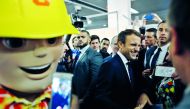 France's President Emmanuel Macron (C) smiles as he visits the construction fair in Paris, on October 6, 2017.  AFP/ Thibault Camus