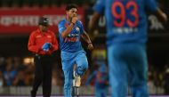 India's Kuldeep Yadav (C) celebrates the wicket of Australia's Aaron Finch during the first twenty 20 match between India and Australian at the JSCA international stadium in Ranchi on October 7, 2017. (AFP / Money SHARMA)