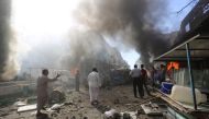 Smoke rises from material caught on fire after an airstrike hit a marketplace in Maarrat al-Nu'man town of Idlib, Syria on October 8, 2017.   Muhammed Karkas - Anadolu Agency 
