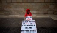 A man holds a placard reading 