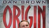 US author Dan Brown poses in front of a poster promoting his new book 