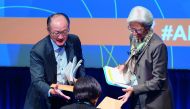 IMF Managing Director Christine Lagarde (right) and World Bank President Jim Yong Kim, take a folder of questions from a participant at a CSO Townhall at the World Bank headquarters in Washington DC.