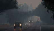 Cars drive through thick smoke along Route 29 on October 13, 2017 in Yountville, California. Justin Sullivan/AFP
