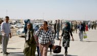 People walk through the reopened Erbil-Mosul road after Peshmerga forces, loyal to northern Iraqi Kurdish Regional Government (IKRG), have closed the main roads that linking the both cities in Erbil, Iraq on October 12, 2017. Yunus Kele? - Anadolu Agency
