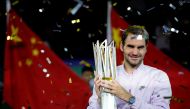 Roger Federer of Switzerland lifts the trophy after winning against Rafael Nadal of Spain. REUTERS/Aly Song
