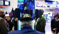A trader wears a hat reading Dow 23,000 on the floor of the New York Stock Exchange (NYSE) on October 17, 2017 in New York City. The Dow Jones Industrial average briefly rose to 23,000 today before closing 2.56 below 23,000 at 22,997. Spencer Platt/Getty 