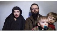 A still image from a video posted by the Taliban on social media on December 19, 2016 shows American Caitlan Coleman speaking next to her Canadian husband Joshua Boyle and their two sons (Taliban / via Reuters) 