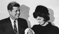 This December 10, 1960, file photo shows John F. Kennedy and his wife Jacqueline holding their son John during the christening ceremony at the chapel of Georgetown University in Washington, DC. / AFP / SAM SCHULMAN