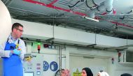 Students from Qatar University listen to an expert about biobanking and other laboratory techniques during the Qatar Biobank Summer Experience Program.

