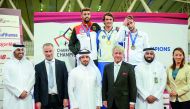 The podium winners, Italian penathlete Riccardo De Luca, Patrick Douge of Germany and France’s Valentin Belaud pose for a photograph with officials of Qatar Equestrian Federation and International Modern Pentathlon Federation (UIPM) during the prize distr