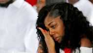 Myeshia Johnson, widow of U.S. Army Sergeant La David Johnson, who was among four special forces soldiers killed in Niger, sits with her daughter, Ah'Leeysa Johnson at a graveside service in Hollywood, Florida, October 21, 2017. Reuters/Joe Skipper