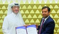 Fahad Rashid Al Kaabi (left), CEO of Manateq, receiving the ISO certificates.