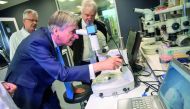 Britain's Finance Secretary Philip Hammond uses a microscope to examine protein crystals during his visit to The Francis Crick Institute in London, Britain October 25, 2017. Reuters/Chris J Ratcliffe