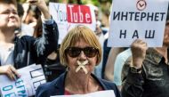 A file photo of a protester with tape covering her mouth takes part in the March for Free Internet in central Moscow in July. AFP / Mladen ANTONOV