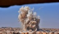 File photo of smoke rising from buildings in Deir Ezzor. Reuters 