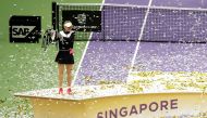 Denmark's Caroline Wozniacki celebrates with the trophy after winning the final against USA's Venus Williams REUTERS/Jeremy Lee

