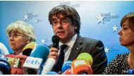 Catalonia's dismissed leader Carles Puigdemont (centre) along with other members of his dismissed government address a press conference at The Press Club in Brussels. (Aurore Belot/AFP).