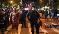 NYPD officers stand guard during the 44th Annual Halloween Parade in New York on October 31, 2017. / AFP / ANGELA WEISS