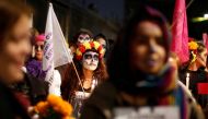 A file photo of activists with faces painted to look like the popular Mexican figure 