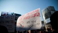 US residents in Japan display placards during a demonstration against US President Donald Trump in Tokyo on Nov 5, 2017. PHOTO: AFP.