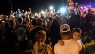 Local residents embrace during a candlelight vigil for victims of a mass shooting in a church in Sutherland Springs, Texas, U.S., November 5, 2017. REUTERS/Mohammad Khursheed.