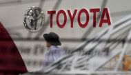 This file photo taken on September 19, 2017 shows visitors walking at the Mega Web Toyota showroom in Tokyo. Japanese car giant Toyota on November 7, 2017 revised its full-year net profit forecast higher thanks to a cheaper yen and cost-cutting efforts. A