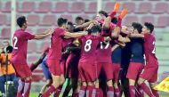 Qatar players celebrate their win over Iraq in Group C match of the AFC U-19 Championship 2018 in Doha yesterday. Qatar qualified for the finals rounds in Indonesia. 