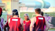 Joe Dharshan Goonethillaka (centre), from Doha Maroon, discusses team tactics ahead of the game against Blue Phoenix.
