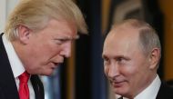 US President Donald Trump (L) chats with Russia's President Vladimir Putin as they attend the APEC Economic Leaders' Meeting, part of the Asia-Pacific Economic Cooperation (APEC) leaders' summit in the central Vietnamese city of Danang on November 11, 201