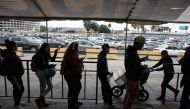 People line up on the pedestrian crossing lines on the Mexican side of the San Ysidro Port of Entry on November 1, 2017, in Tijuana, northwestern Mexico. AFP / GUILLERMO ARIAS
