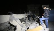 Iraqis search for the trapped citizens over the collapsed buildings after a 7.3 magnitude earthquake hit northern Iraq in Derbendihan district of Sulaymaniyah, Iraq on November 12, 2017. (Feriq Fereç - Anadolu Agency)
