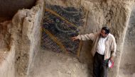 A handout file photo taken and released by Peruvian national news service Andina on November 10, 2007 shows Peruvian archaeologist Walter Alva pointing what is supposed to be the most ancient mural painting in America, in a temple in Chiclayo, more than 1