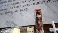 Flowers and candles are left in front of a plaque for victims of a shooting at La Belle Equipe cafe - restaurant during ceremonies across Paris marking the second anniversary of the terror attacks of November 2015 in which 130 people were killed, in the F