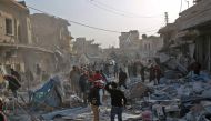 Syrians dig through the debris of a building as they search for survivors following a reported airstrike on the rebel-held town of Atareb in Syria's northern Aleppo province on November 13, 2017.  AFP / Zein Al RIFAI
