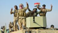 raqi forces show victory signs after they captured Rawa town, the last remaining town under Islamic State control, Iraq November 17, 2017. Reuters/Stringer