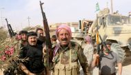 Iraqi pro-government forces gather in Rawa on November 18, 2017, after troops retook the Euphrates valley town from Islamic State group jihadists. Suleiman al-Anbari, AFP.