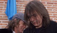 A file photo of Australian guitarists and brothers Angus (L) and Malcolm Young of the hard rock group ACDC inaugurating the first street in the world bearing their group's name in Leganes, 29 kms from Madrid March 22, 2000.  / AFP / CHRISTOPHE SIMON
