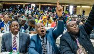 War Veterans leader Christopher Mutsvangwa (C) celebrates the dismissal of the president of the ruling ZANU-PF party on November 19, 2017 in Harare. Zimbabwe's ruling party ZANU-PF sacked President Robert Mugabe as party leader on November 19 marking the 
