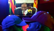 People watch as Zimbabwean President Robert Mugabe addresses the nation on television in Harare, Zimbabwe, November 19, 2017. Reuters/Philimon Bulawayo