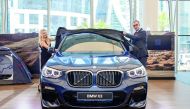 Ma’n Alhamawi (right), COO of Alfardan Automobile, unveiling the all-new BMW X3 before the media yesterday at BMW West Bay showroom.