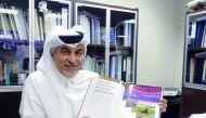 Author and sports administrator Abdulla Y Al Mulla poses for a photograph with his book titled ‘Perfect Pitch’.