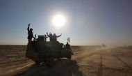 Iraqi forces, supported by members of the Hashed al-Shaabi (Popular Mobilisation units), advance through the Salaheddin province in the western desert bordering Syria after leaving the town of Baiji, on November 24, 2017, as they attempt to flush out rema
