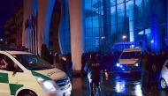 Georgian police investigators and ambulance cars are seen in front of the Leogrand hotel in Georgia's Black Sea resort city of Batumi on November 24, 2017. At least 12 people died and a dozen were injured on November as a fire ripped through an upmarket h