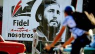 A man walks past a poster of late Cuban leader Fidel Castro in Havana. (YAMIL LAGE/AFP).