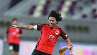 Al Rayyan’s  Rodrigo Tabata (left) vies for ball possession with an Al Gharafa player during the QNB Stars League at Khalifa International Stadium yesterday. 
