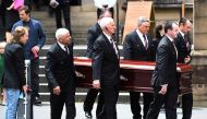 Angus Young holds a guitar as the casket of his brother AC/DC co-founder and guitarist Malcolm Young is carried to a hearse following his funeral at St. Mary's Cathedral in Sydney November 28, 2017. AAP/Dean Lewins/via Reuters 