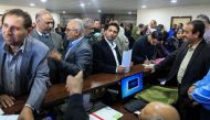 Government employees of the Palestinian Authority gather to return to work at the headquarters of the Palestinian Finance Ministry in Gaza City on November 29, 2017.  AFP / Mohammed Abed